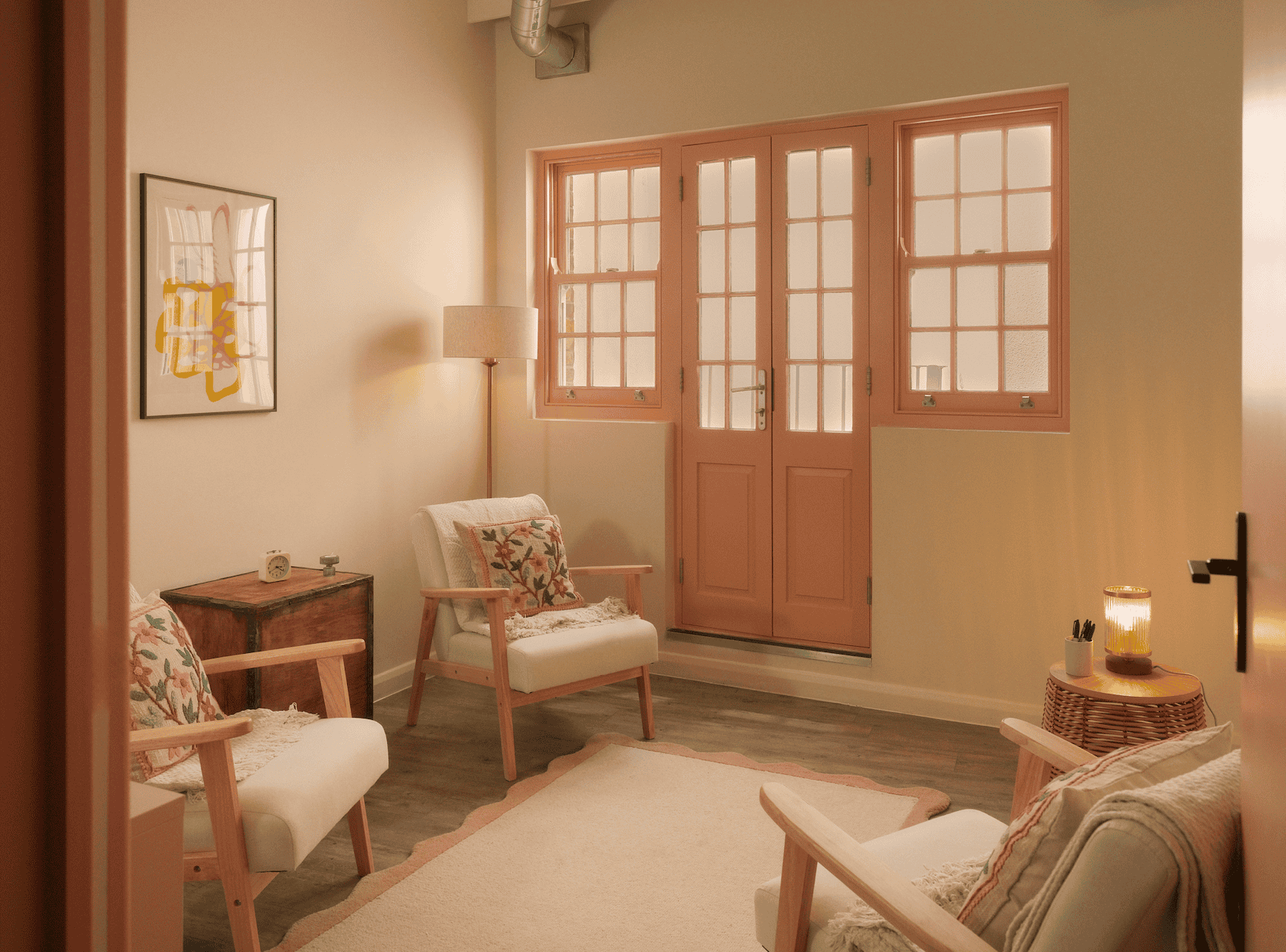 A bright warmly lit therapy room with three chairs